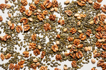 Dry nuts background. Nuts pattern from above. Different types of nuts on a white background