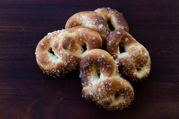 Pretzel with salt on wood 