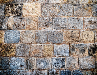 rough stone wall closeup, seamless pattern textured background, filtered image