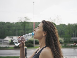 young woman goes in for sports in the stadium, running, jumping rope, warm-up and stretching