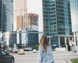 
young woman extinguishes in the city near the skyboxes and in the subway
