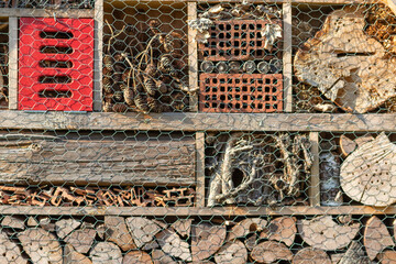 Organic bee hotel as nesting place with holes in wood for nature protection of species and hole...