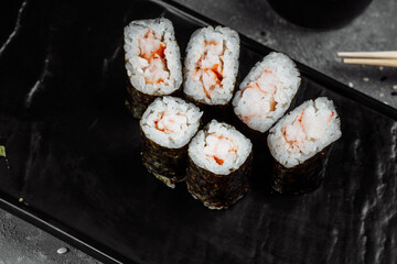 Simple maki with shrimp. Sushi on a gray background