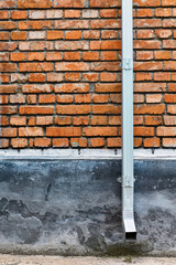 old red brown brick wall and drain pipe for background or texture