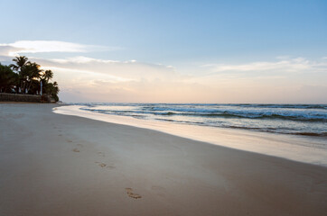 Empty sandy beach at sunrise