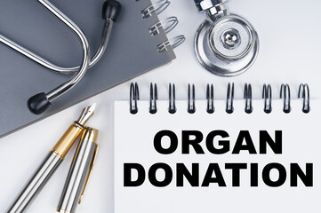 On the table are a stethoscope, a pen and a notebook with the inscription - ORGAN DONATION