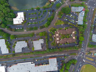 In the photo, we see a suburb taken from the air by a drone. We see houses, a lot of greenery,...