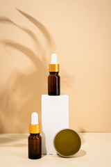 brown bottles mockup for natural skincare cosmetics, spa accessories on white podiums, cream background