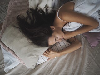 young beautiful woman sleeping sweetly in bed. and drinks vitamins