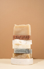 tower stack of different handmade soaps on cream background