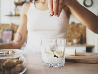 young woman is making a healthy breakfast in her kitchen, vegan