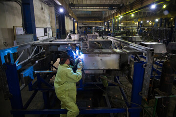 Welders working at the factory made metal