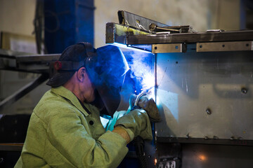 Welders working at the factory made metal