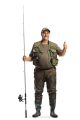 Full length portrait of a fisherman in a uniform standing with a fishing rod and showing thumbs up