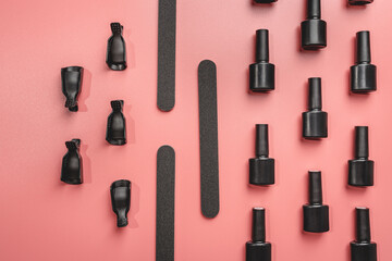 manicure and pedicure tools and other nail essentials on pink background top view. nail work flat lay concept