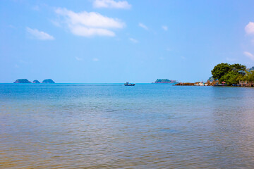 Seascape. A fisherman's boat is sailing on the sea in the background. Travel and tourism.