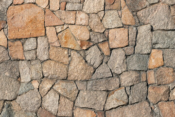 Stone wall of granite close-up, texture, background