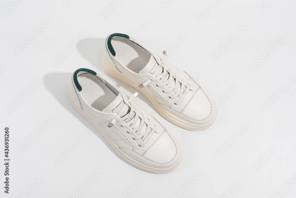 Wall mural women's white leather sneakers with thick soles