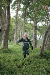 Fototapeta na wymiar Woman playing in the forest