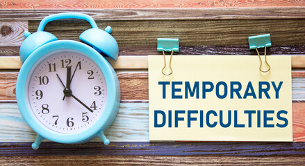 text TEMPORARY CHALLENGES written on a warning sticker on a striped background