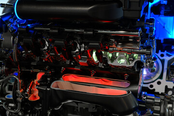 the internal combustion engine of a car in a section to demonstrate the internal parts. A mock-up of the engine at the exhibition.