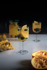 orange coktail on glass with blueberries