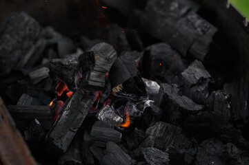 the process of lighting charcoal in the grill