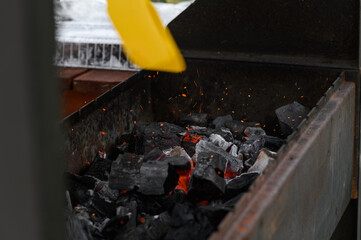 the process of lighting charcoal in the grill