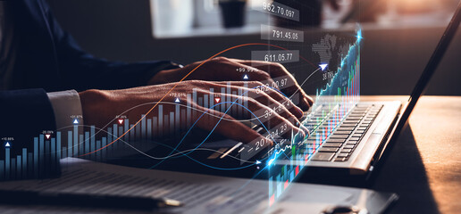 Businessman working on laptop with growth digital graphics  and progress of business. Business planning and investment data  strategy.