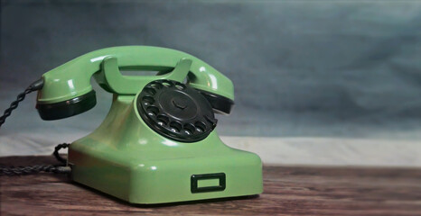A vintage green, cable telephone set. A symbol of contact and connecting. Angle view photo with copy space for text