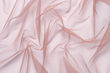 wrinkled, compressed fabric mesh tulle pink on white isolated background close-up. background for...