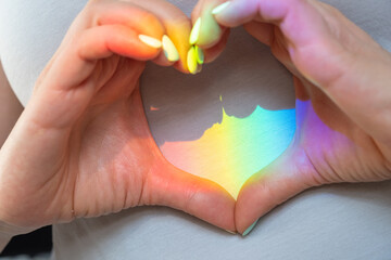 Rainbow color spectrum light on the chest. Heart rainbow