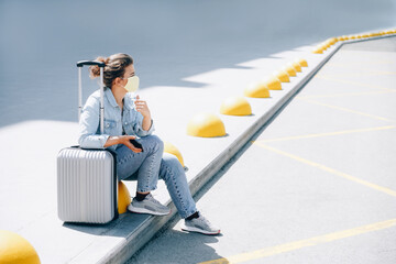 Young woman traveler at the station waiting for taxi