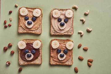 Funny children bear toasts with nuts butters for breakfast