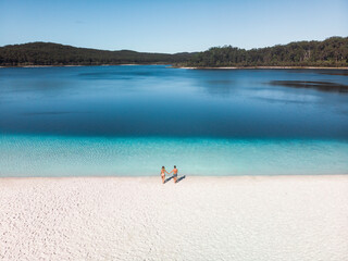 Aerial view of a couple walking down towards the water at Lake McKenzie, Fraser Island, Queensland, Australia.
