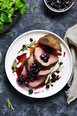 Sliced grilled beef with blueberry sauce