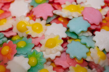Fototapeta na wymiar Multicolored jelly flower candies background