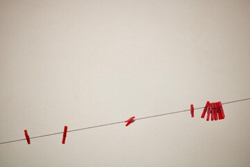 red clips hanging on clothes line