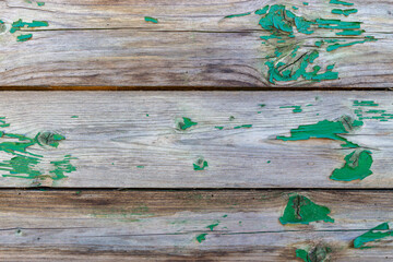 Wooden wall texture with green flaking paint residues