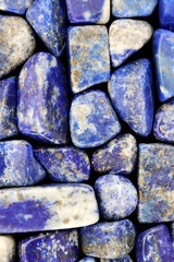 Lapis lazuli heap jewel stones texture on black background