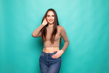 Advertising concept. Portrait of young woman isolated on vivid turquoise background