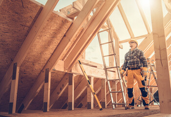 Professional Construction Worker Inside Newly Built Wooden Frame House