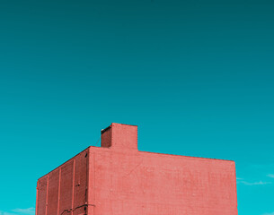 Red building against a clear blue sky