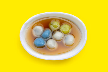 Black sesame dumpling in ginger tea recipes on yellow background.