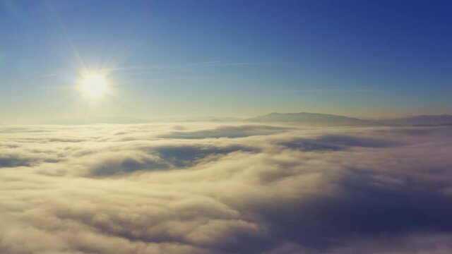 Wonderful view of extraordinary cloudy valley and bright orange sunset