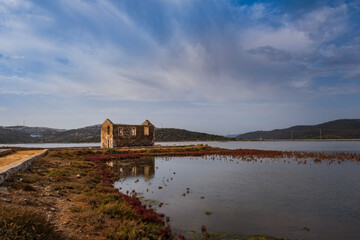 Fototapeta na wymiar Dorttepe, Milas, Kavaklarbogazi Creek or bay of Aegean sea in Turkey. October 2020. Old ruined building and bay, where you can often find pink flamingos