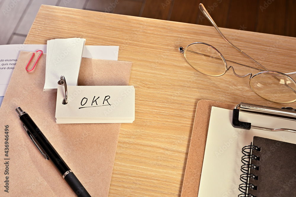 Poster there is a word book with the word of okr which is an abbreviation for objectives and key results on