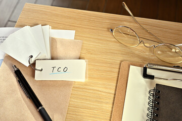 There is a word book with the word of TCO which is an abbreviation for Total Cost Ownership on the...