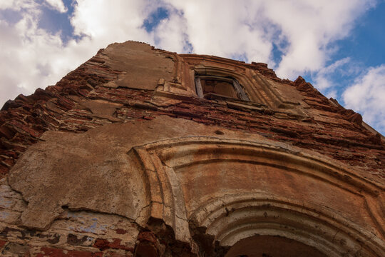 The wall of an abandoned old church against a cloud sky. Russia, Smolensk region, 1753.