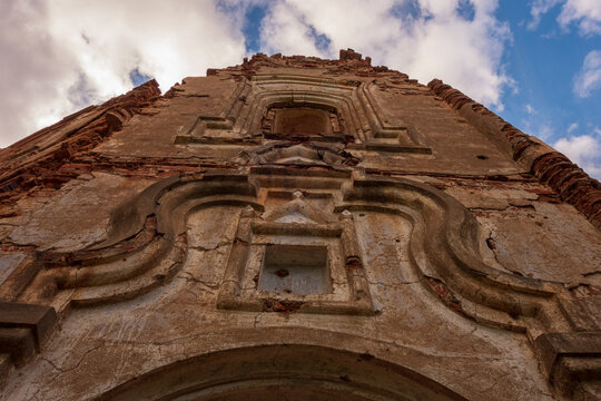 Abandoned old church with showered plaster in cloudy weather. Russia, Smolensk region, 1753.